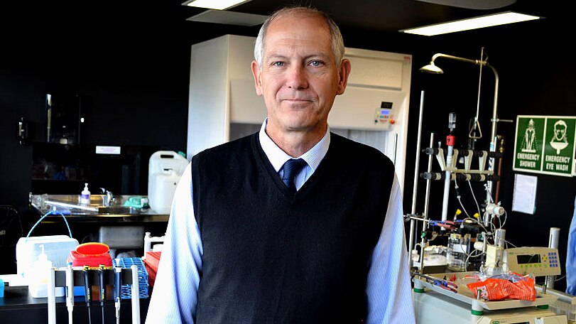Professor Doug Brooks stands in a laboratory.