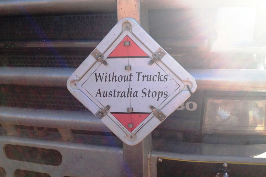 A sign on the truck bumper bar reads "Without trucks, Australia stops"
