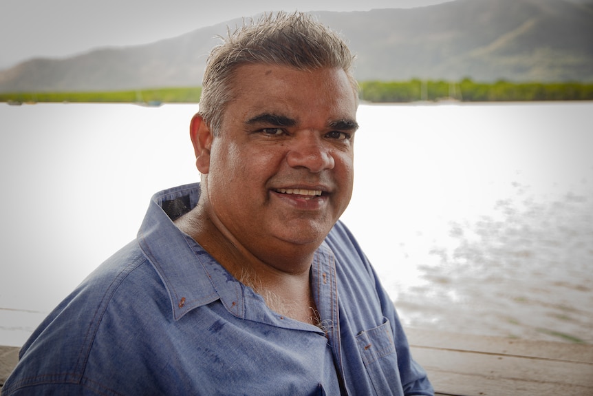 Portrait of man beside harbour.