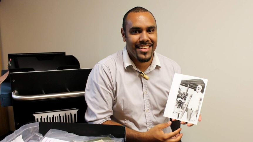 John Morseu with material from the Torres Strait collection at the National Library.