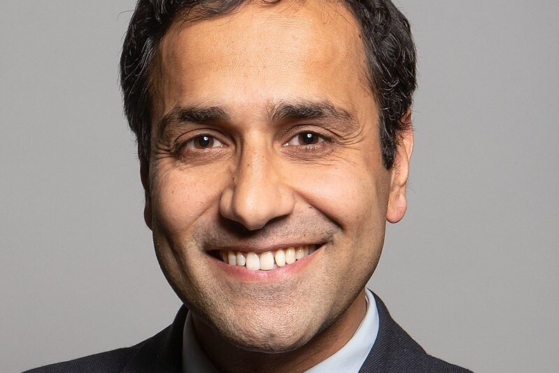 Close up on Rehman Chishti smiling.
