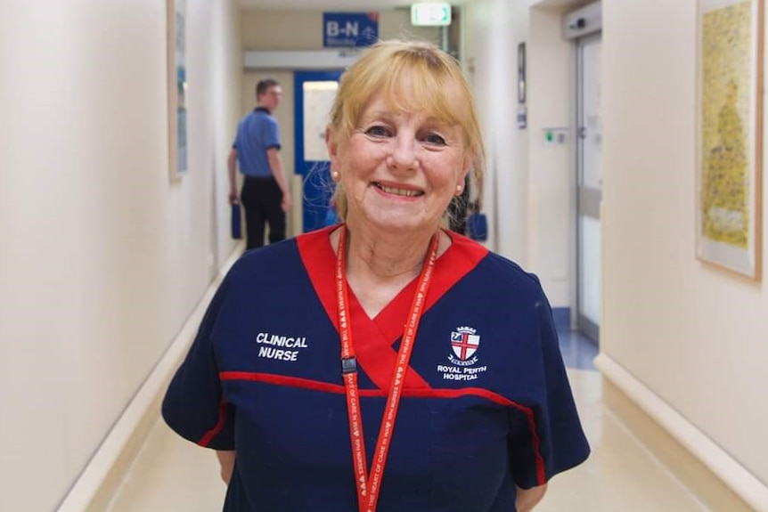 A nurse poses for a photo smiling in a corridor at Royal Perth Hospital.