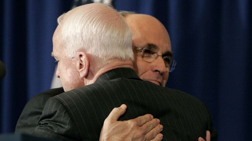 Rudy Giuliani, right, hugs Senator John McCain