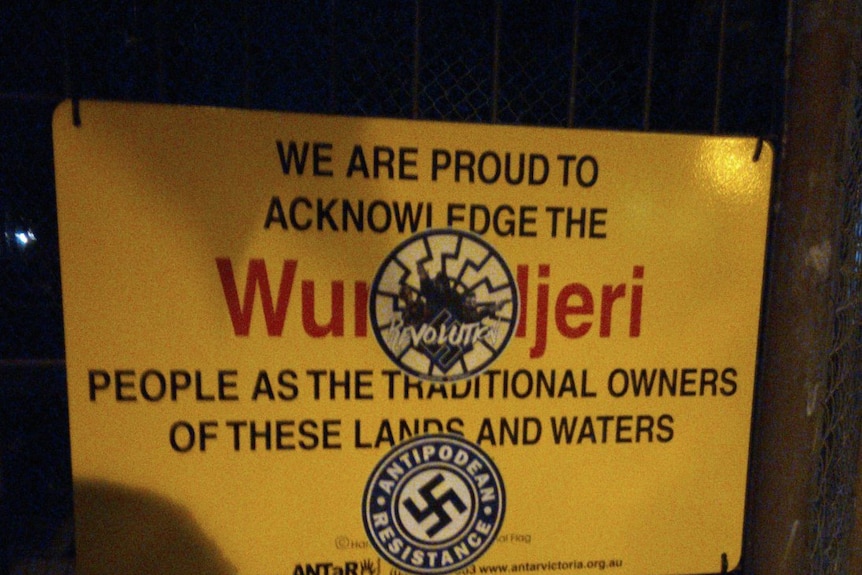 An Antipodean Resistance swastika sticker on a sign recognising traditional Aboriginal owners.