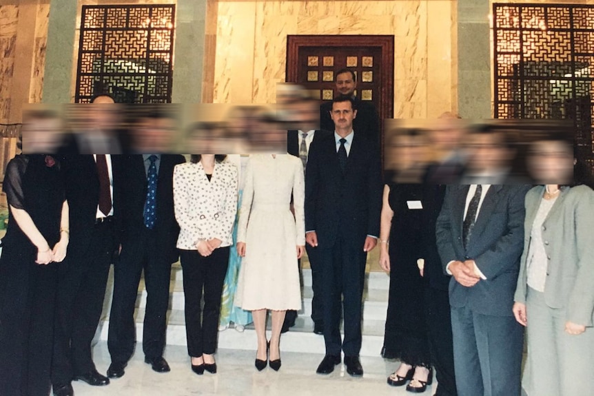 Dr Zaher Sahloul standing behind Bashar al-Assad in 2002