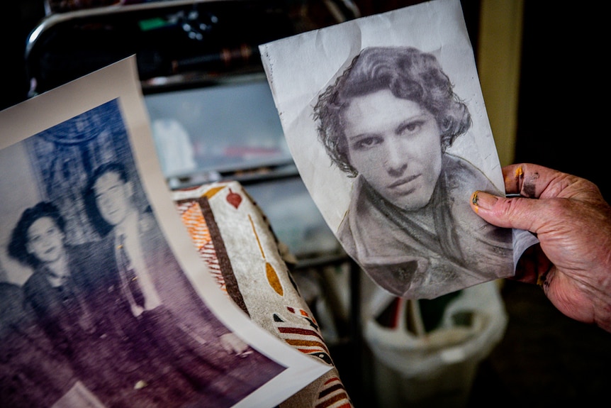 Danny Eastwood holds a black-and-white photo of his mother.