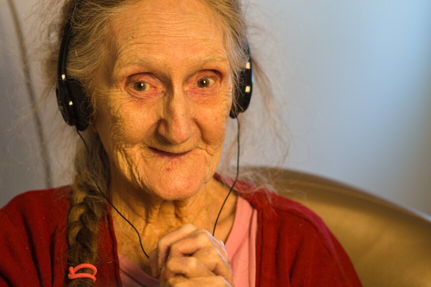 Older woman with headphones.