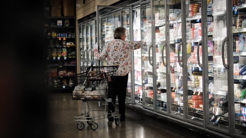 Woman grocery shopping in dairy aisle