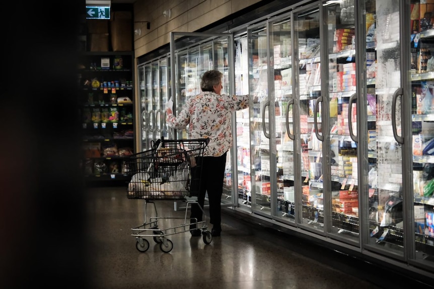 Woman grocery shopping in dairy aisle