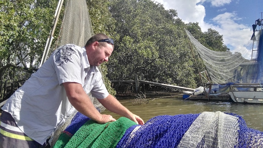 Mr Wilkinson on his prawn fishing boat at Bulimba Creek, in the Brisbane suburb of Hemmant.