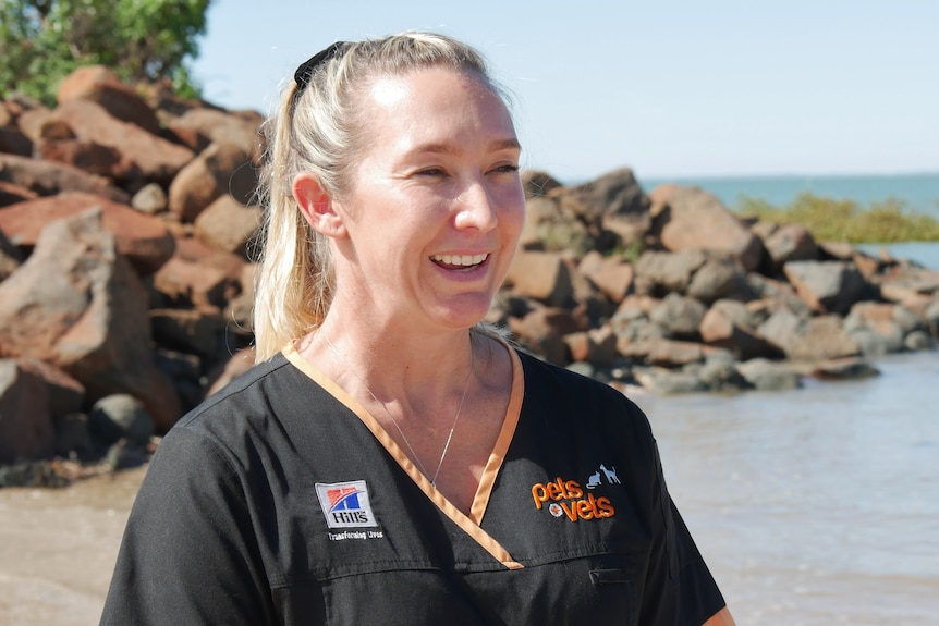 A woman in a work uniform.