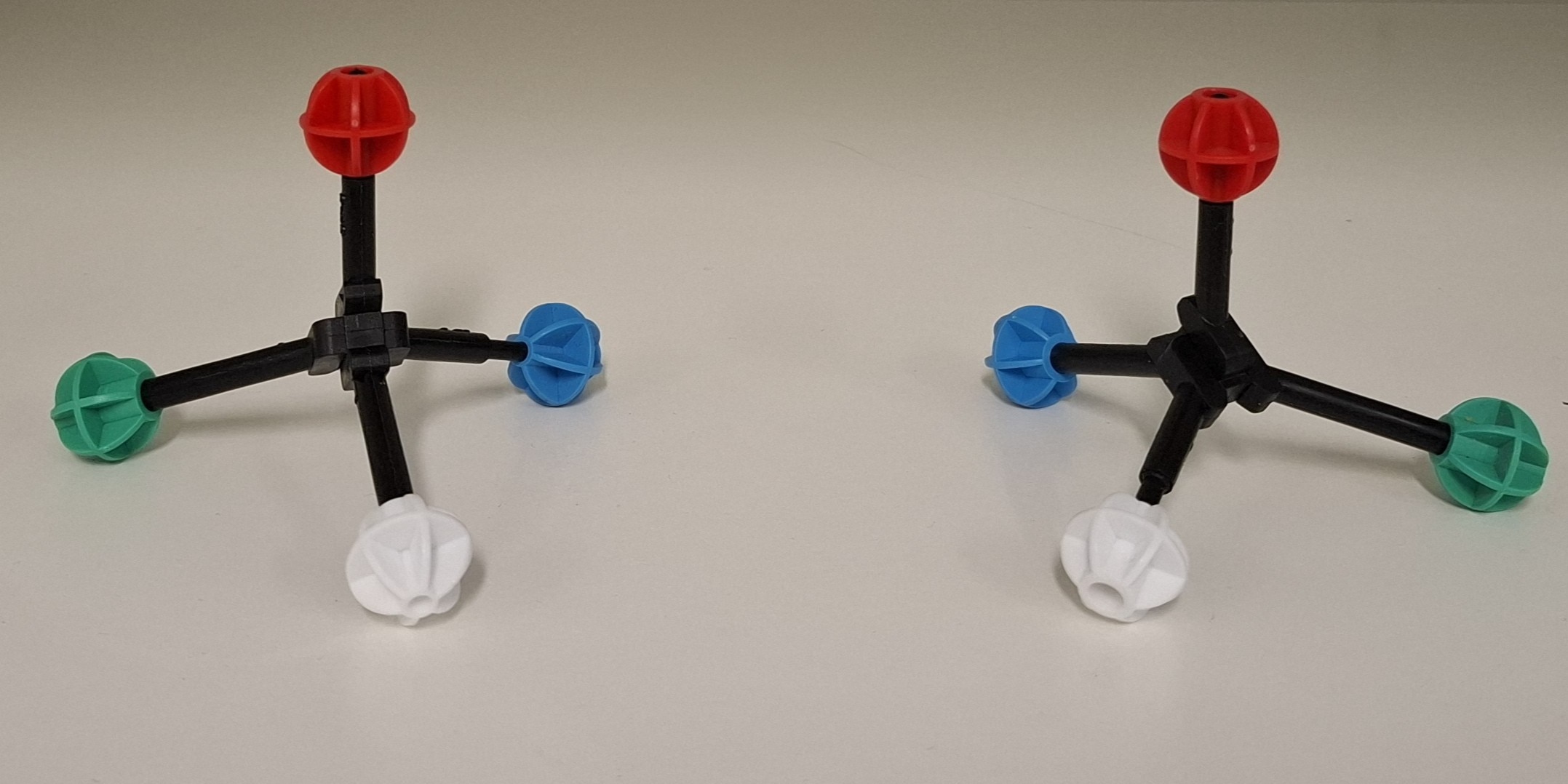Two plastic models of molecules, made of identical parts, with one the mirror image of the other.