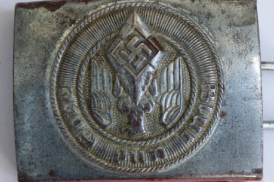 A silver belt buckle with a swastika on it, labelled as a Hitler Youth buckle