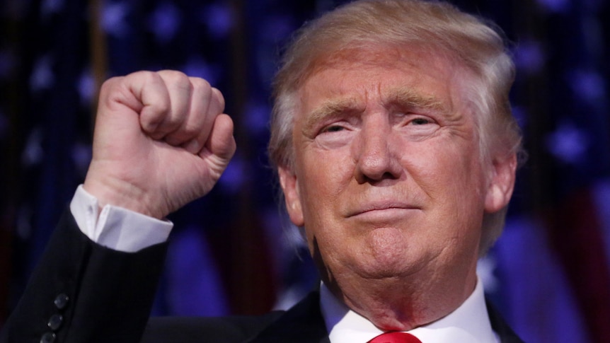 US President Donald Trump pumps his fist.