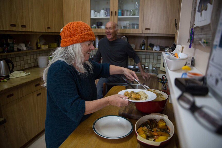 Karen and Tony share a laugh as Karen dishes up a dinner of curried fish.