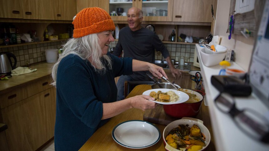 Karen and Tony share a laugh as Karen dishes up a dinner of curried fish.