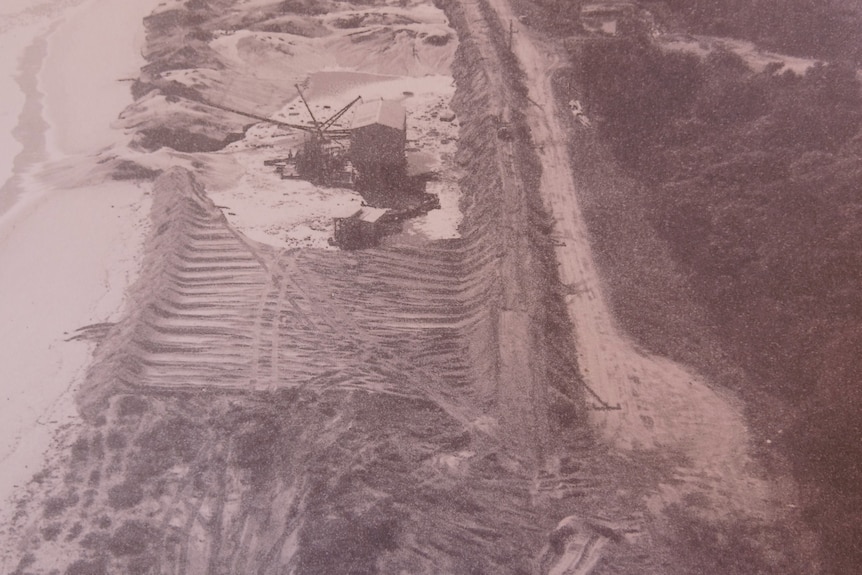 Old historical photo of a beach being scraped for sand mining