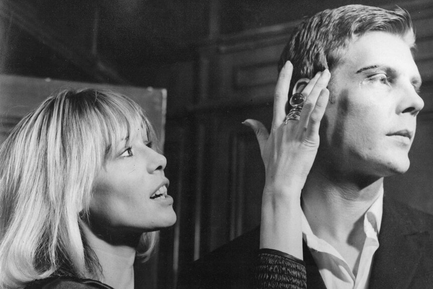 Anita Pallenberg touches the face of James Fox.