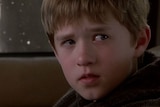 Haley Joel Osment looks out of the corner of his eyes