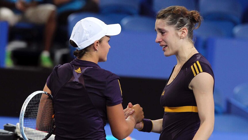 Germany's Andrea Petkovic (R) shakes hands with Australia's Ashleigh Barty (L) after retiring.