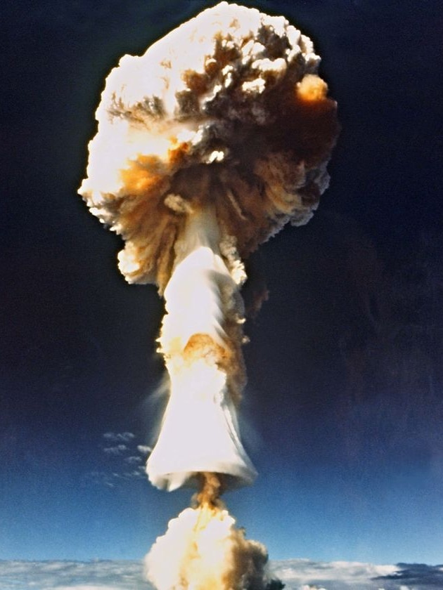 A mushroom cloud rises above Mururoa Atoll