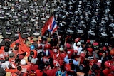 Red shirts confront security