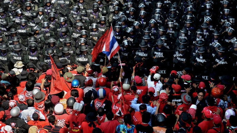 Red shirts confront security