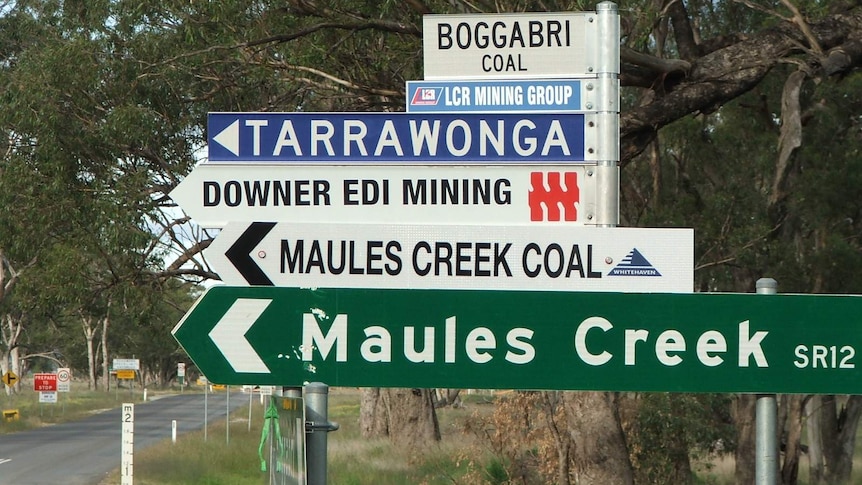 Road sign for Maules Creek and four other signs pointed to mine sites