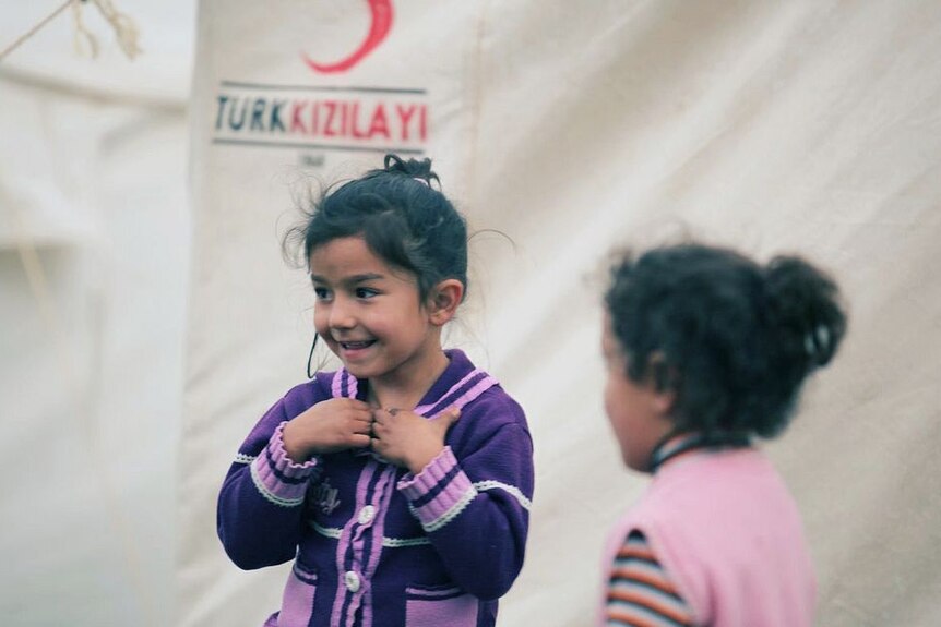 Children laugh in a Turkish tent city