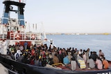 Migrants wait to disembark in the Sicilian harbour of Augusta, Italy, May 30, 2015.