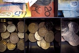 Australian dollars and coins in a till
