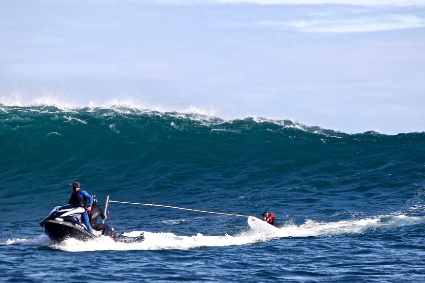 Paul D'Vorak, quadriplegic surfer, being towed by jet ski to catch a wave at the Gallows