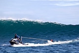 Paul D'Vorak, quadriplegic surfer, being towed by jet ski to catch a wave at the Gallows