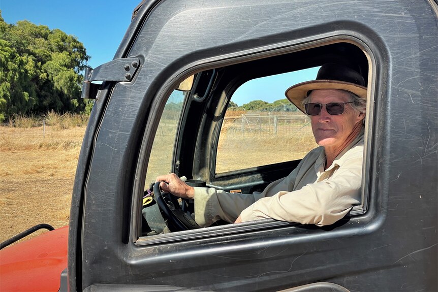 Older male farmer sitting in his farm vehicle on a property in Southern W-A..