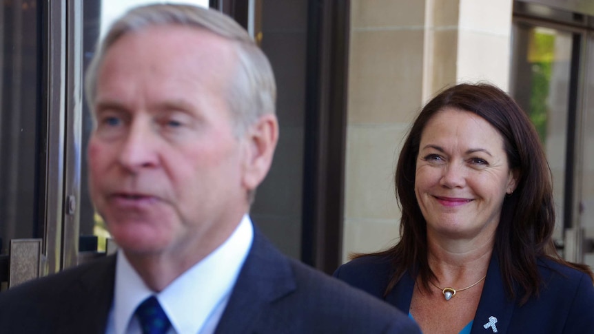 WA Premier Colin Barnett, blurred in foreground, with Deputy Premier Liza Harvey behind.