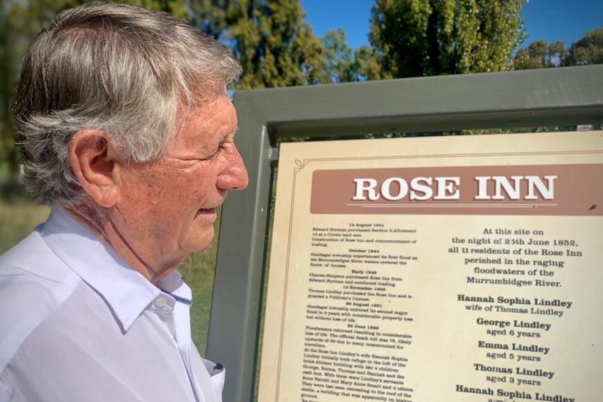 Man gazing at memorial plaque