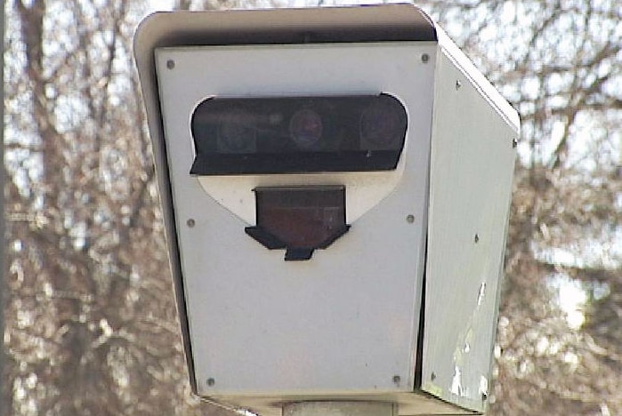 A close-up of a mounted speed camera.
