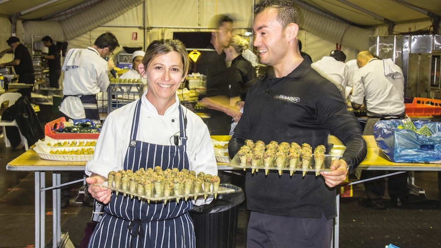 Shot of Kate Strange and Giovanni Sanchez from Beaumonde Catering holding canapes at the Diggers and Dealers Mining Forum