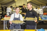 Shot of Kate Strange and Giovanni Sanchez from Beaumonde Catering holding canapes at the Diggers and Dealers Mining Forum
