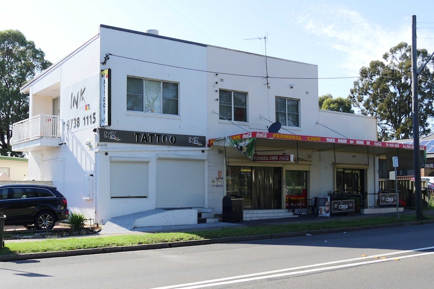 The exterior of Ink tattoo parlour and an adjacent cafe