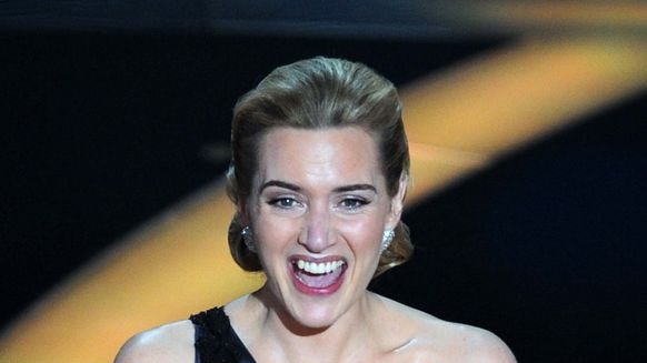 Kate Winslet clutches her Oscar after winning the Best Actress category