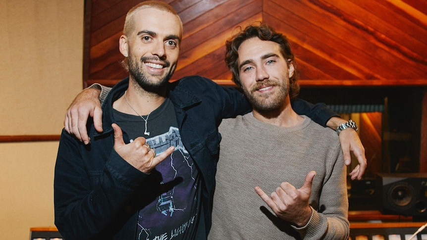 A 2019 shot of producer Dann Hume and Matt Corby giving shakas in the studio