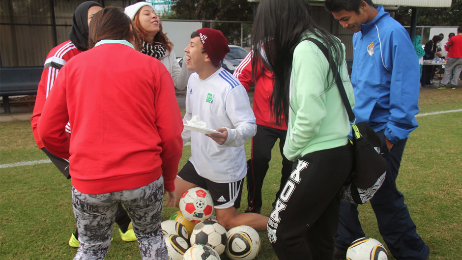 Young people joke around at a Football United event.