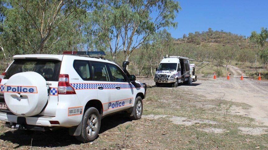 Police vehicles at a crime scene at Lake Moondarra near Mount Isa.