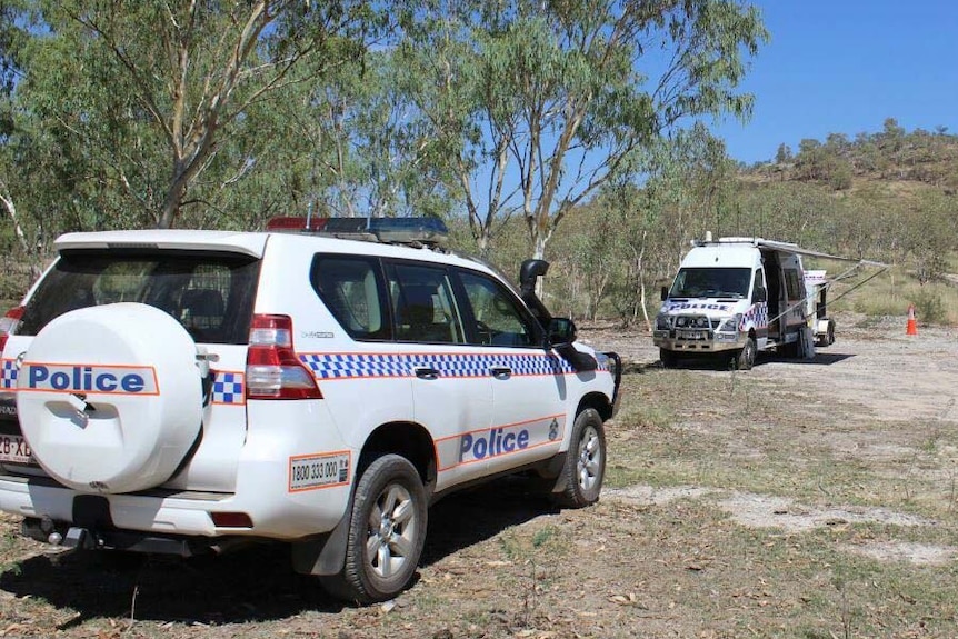 Police vehicles at a crime scene at Lake Moondarra near Mount Isa.