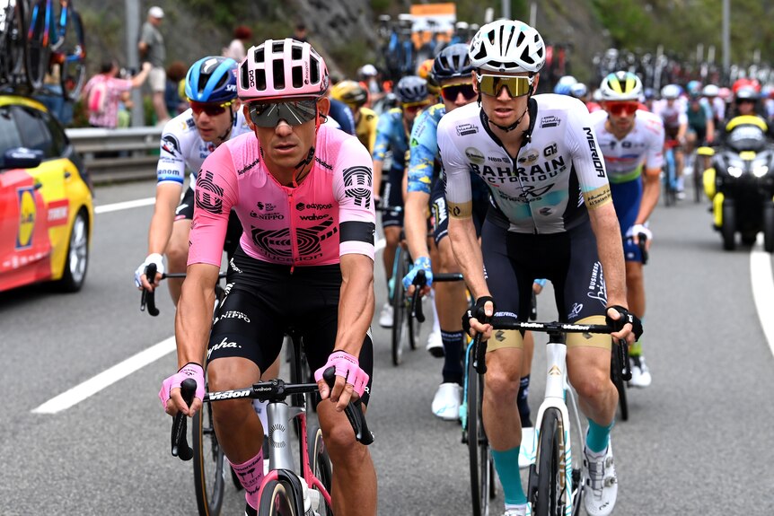 Two men front on during a cycling race.