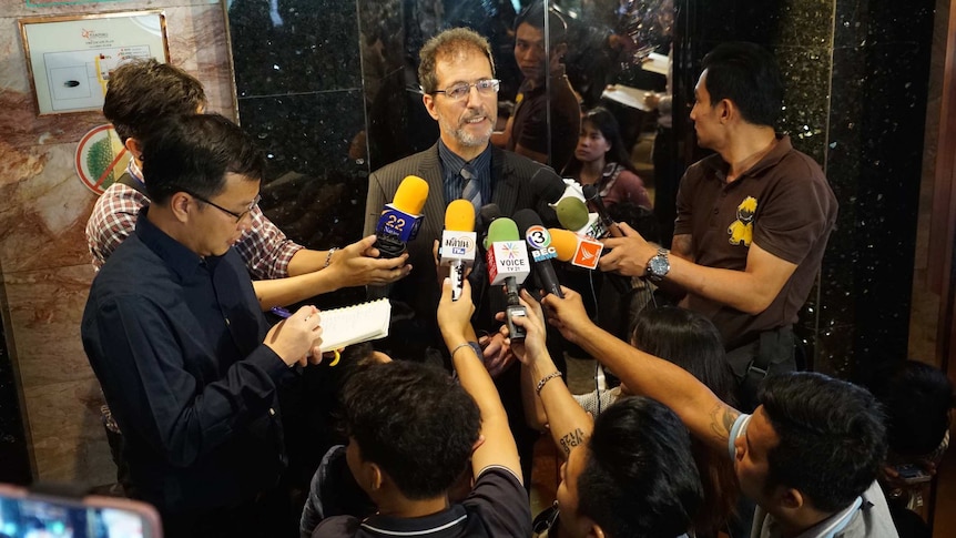 Amnesty International's Yuval Ginbar speaks to media outside an official event that was shut down by Thai authorities.
