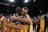 Two Tasmania JackJumpers players embrace after defeating Perth Wildcats.