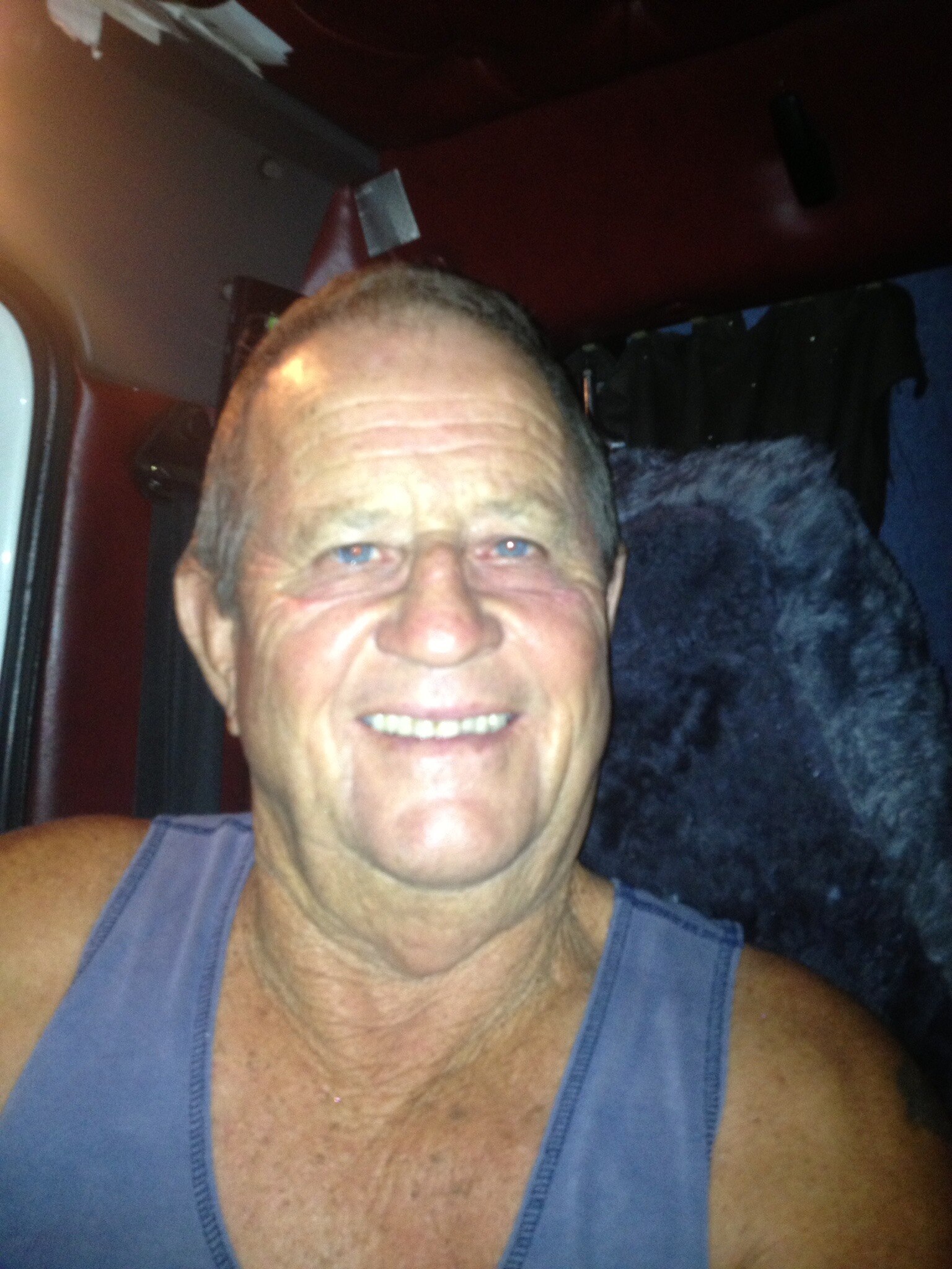 A Facebook profile photo of a man in a singlet.