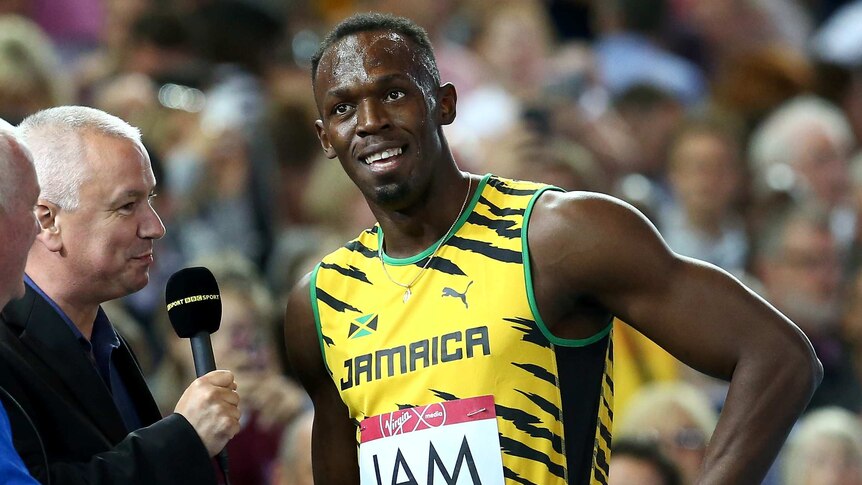 Bolt talks to the media after 4x100m heats